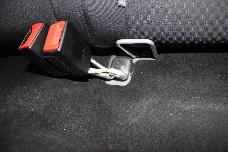 locate the bolts securing the adult buckles