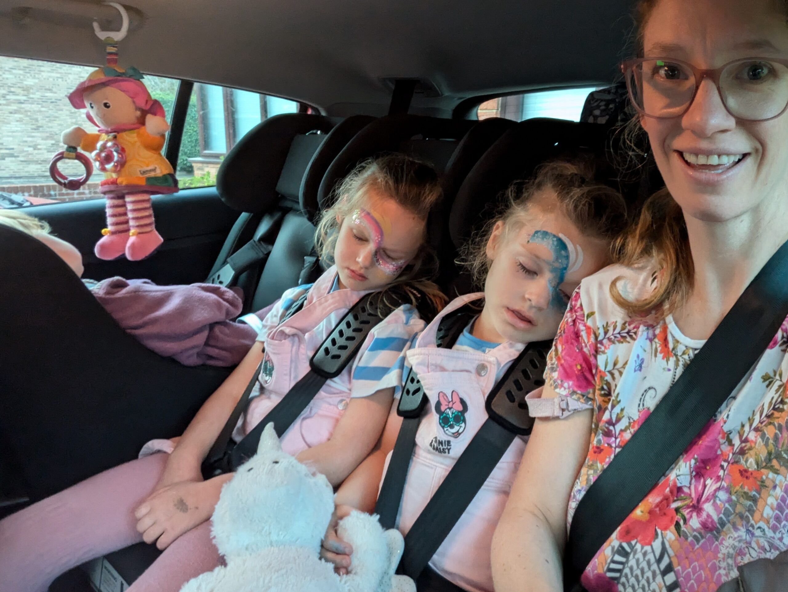 1260 with baby and adult Adult, 2 children and baby in back of 5 seater car